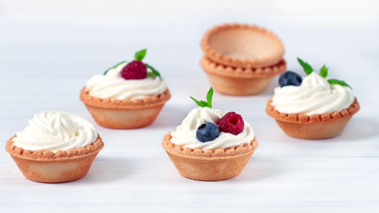 Mini tartlets with whipped cream and fresh berries