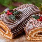 Traditional Christmas cake, chocolate Yule log with festive decorations