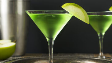 Homemade Green Alcoholic Appletini Cocktail with Apple Garnish