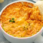 Buffalo chicken dip served with chips and fresh vegetables