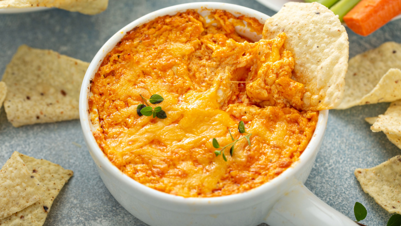 Buffalo chicken dip served with chips and fresh vegetables