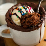 Chocolate mug cake with ice cream and festive sprinkles