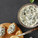 Spinach appetizer or dip with sour cream and bread.