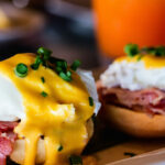 Delicious breakfast with eggs Benedict and juice