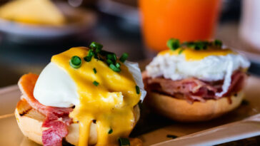 Delicious breakfast with eggs Benedict and juice