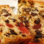 delicious sliced fruit cake with mixed fruit and cherries