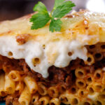 Greek Pastitsio dish on a blue plate.