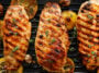 Grilled chicken breasts with thyme, garlic and lemon slices on a grill pan