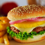 A hawaiian style hamburger with pineapple in the middle
