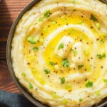 Delicious creamy mashed potatoes with butter, fresh herbs and freshly-cracked black pepper.