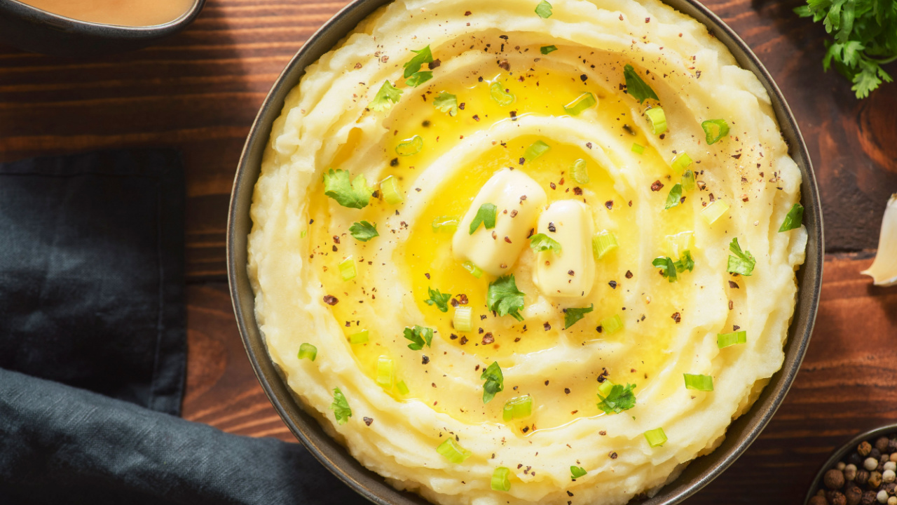 Delicious creamy mashed potatoes with butter, fresh herbs and freshly-cracked black pepper.