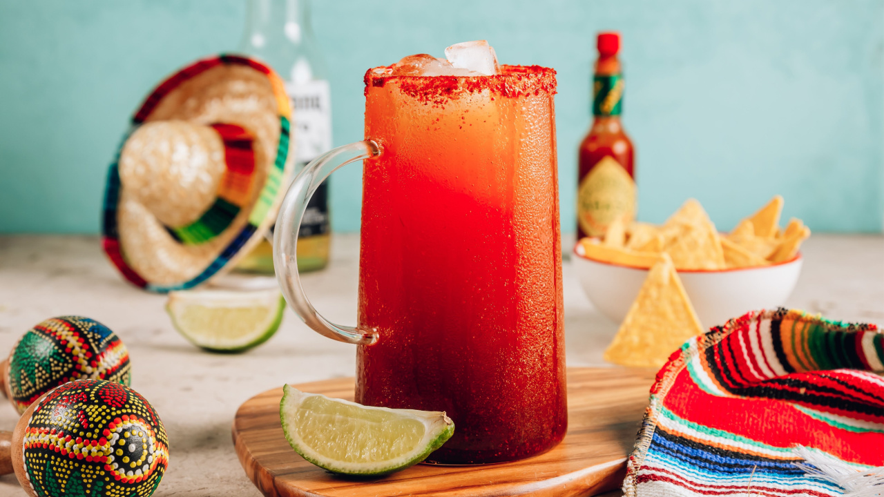 Michelada - Mexican inspired cocktail with beer, lime juice, tomato juice, spicy sauce and spices.