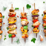 Grilled vegetable and chicken skewers with bell peppers, zucchini, onion and mushrooms.