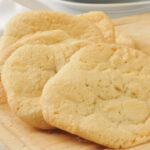 Fresh baked sugar cookies cooling on a cutting board
