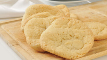 Fresh baked sugar cookies cooling on a cutting board