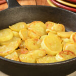 Sauteed summer squash in a cast iron skillet.